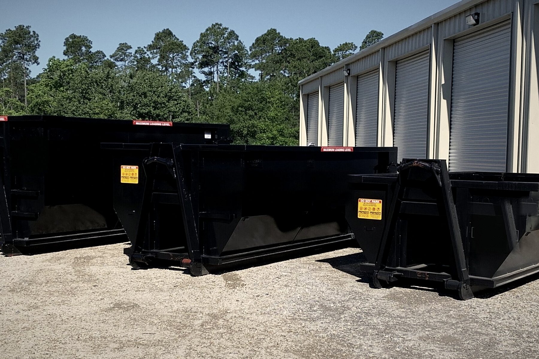 15, 20 and 30 yard roll-off containers staged in the yard